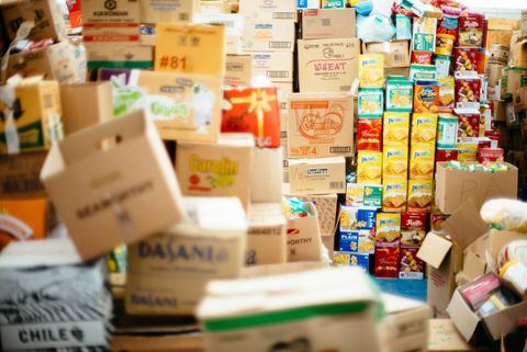 Stacks of a variety of cardboard and food boxes, some leaning precariously.