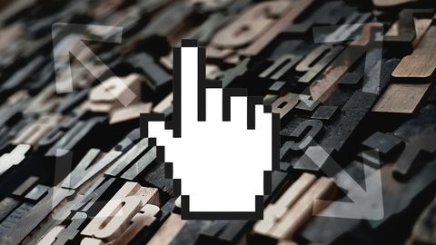 A case of letterpress type with arrows pointing outward and a cursor hand overlaid